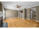 Living room with hardwood floors, fireplace, and windows with white shutters at 10455 Alexander Martin Ave, Charlotte, NC 28277