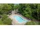 Overhead view of fenced pool and surrounding lounge area among mature trees at 10455 Alexander Martin Ave, Charlotte, NC 28277