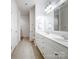 All-white bathroom with double vanity and ample counter space is bright and airy at 10875 Casetta Dr, Matthews, NC 28105