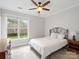 Cozy bedroom with large window providing ample natural light and outside view at 10875 Casetta Dr, Matthews, NC 28105