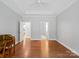 Cozy bedroom featuring hardwood floors and natural light at 10875 Casetta Dr, Matthews, NC 28105