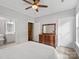 Comfortable bedroom with ensuite bath and classic wooden dresser offers charm and convenience at 10875 Casetta Dr, Matthews, NC 28105