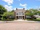 Charming community clubhouse with stone accents, a balcony, and well-maintained landscaping at 10875 Casetta Dr, Matthews, NC 28105