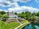Beautiful clubhouse with a pool, lounge chairs, and manicured landscaping near a pond and bridge at 10875 Casetta Dr, Matthews, NC 28105