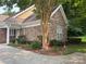 Close-up of the exterior showcasing the stone facade, manicured landscaping, and architectural details at 10875 Casetta Dr, Matthews, NC 28105