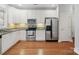 Well-lit kitchen showcasing stainless steel appliances and white cabinetry at 10875 Casetta Dr, Matthews, NC 28105