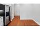 Spacious area with a stainless steel refrigerator and hardwood flooring at 10875 Casetta Dr, Matthews, NC 28105