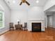 Inviting living room features a fireplace, hardwood floors, and bright, neutral walls at 10875 Casetta Dr, Matthews, NC 28105