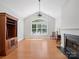 Sunlit living room with a fireplace, large window, and vaulted ceiling creating a warm, inviting space at 10875 Casetta Dr, Matthews, NC 28105
