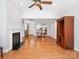 Bright living room with fireplace, ceiling fan, and hardwood floors at 10875 Casetta Dr, Matthews, NC 28105