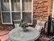 Cozy patio seating area with stone wall and a wrought iron fence at 10875 Casetta Dr, Matthews, NC 28105