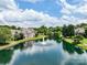 Scenic view of a community pond with a fountain surrounded by lush greenery and well-manicured lawns at 10875 Casetta Dr, Matthews, NC 28105