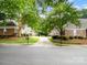 Landscaped street view of brick townhomes presents a welcoming community at 10875 Casetta Dr, Matthews, NC 28105
