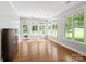Bright sunroom with large windows and hardwood flooring at 10875 Casetta Dr, Matthews, NC 28105