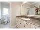 Bathroom with granite countertops, a large mirror and a toilet in the water closet at 1103 Mapesbury Ln, Waxhaw, NC 28173