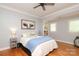 Bedroom featuring hardwood floors, two windows and neutral decor with a queen bed at 1103 Mapesbury Ln, Waxhaw, NC 28173
