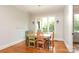 Sunlit dining room with hardwood floors and a charming chandelier at 1103 Mapesbury Ln, Waxhaw, NC 28173