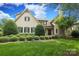 Charming exterior elevation of home with manicured landscaping and mature trees, providing a warm and inviting curb appeal at 1103 Mapesbury Ln, Waxhaw, NC 28173