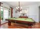 Spacious game room with a billiard table, chandelier, and ample natural light at 1103 Mapesbury Ln, Waxhaw, NC 28173