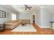Spacious living room with hardwood floors, a ceiling fan, and a comfortable sectional sofa at 1103 Mapesbury Ln, Waxhaw, NC 28173