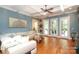 Open living room with hardwood floors, blue accent wall, and ample seating at 1103 Mapesbury Ln, Waxhaw, NC 28173