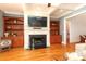 Inviting living room featuring a cozy fireplace and custom built-in shelving at 1103 Mapesbury Ln, Waxhaw, NC 28173