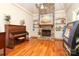 Open-concept living room featuring a stone fireplace and custom built-in shelving at 1103 Mapesbury Ln, Waxhaw, NC 28173