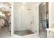 Glass-enclosed shower with marble tile and walk-in closet at 1103 Mapesbury Ln, Waxhaw, NC 28173