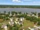 Scenic aerial view of homes in a lakeside community with lush greenery and lake views on a sunny day at 11225 Island View Ln, Lancaster, SC 29720
