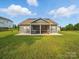 Expansive backyard featuring a well-maintained lawn and screened in patio, ideal for outdoor activities at 11225 Island View Ln, Lancaster, SC 29720