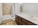 Bathroom featuring double sinks, wooden cabinets, shower with tile surround and blue patterned shower curtain at 11225 Island View Ln, Lancaster, SC 29720