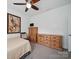 Neutral bedroom showcasing a ceiling fan, artwork, and wooden furniture at 11225 Island View Ln, Lancaster, SC 29720