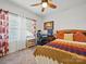 Bright bedroom featuring a ceiling fan, a desk by the window, and a cozy bed with a colorful blanket at 11225 Island View Ln, Lancaster, SC 29720