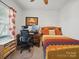 Bright bedroom featuring a ceiling fan, a desk by the window, and a cozy bed with a colorful blanket at 11225 Island View Ln, Lancaster, SC 29720