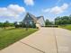 Long driveway leads to a well-maintained home with verdant landscaping and a garage at 11225 Island View Ln, Lancaster, SC 29720