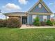 Charming blue home featuring a well-manicured lawn and inviting front porch at 11225 Island View Ln, Lancaster, SC 29720