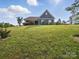 Blue house is nestled on a lush green lawn, perfect for outdoor enjoyment at 11225 Island View Ln, Lancaster, SC 29720