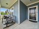 Inviting covered front porch with a swing and chairs for relaxing at 11225 Island View Ln, Lancaster, SC 29720