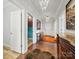 Hallway featuring hardwood floors, unique lighting, and doorway to the laundry room at 11225 Island View Ln, Lancaster, SC 29720