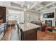 Open kitchen flowing into the living area with a granite countertop island and stainless steel appliances at 11225 Island View Ln, Lancaster, SC 29720