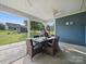 Outdoor patio area with screened-in section and dining table and lush yard view at 11225 Island View Ln, Lancaster, SC 29720