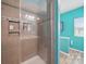 Modern shower with glass door, tiled walls, and built-in shelving for toiletries at 11225 Island View Ln, Lancaster, SC 29720