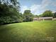 Expansive backyard featuring lush greenery and mature trees provides privacy and a connection with nature at 117 Lincoln Village Dr, Statesville, NC 28677