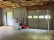 Spacious two-car garage with concrete floors, exposed ceiling, ready for vehicles and storage at 117 Lincoln Village Dr, Statesville, NC 28677