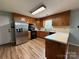 Well-lit kitchen with stainless steel appliances, ample counter space, and wood cabinets for efficient cooking at 117 Lincoln Village Dr, Statesville, NC 28677