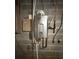 Efficient wall-mounted water heater with modern components against a neutral grey concrete block wall at 117 Lincoln Village Dr, Statesville, NC 28677