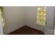Bright bedroom featuring a window, white trim, and wood-look flooring at 1216 Mountain Ave, Gastonia, NC 28052