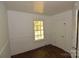 Bedroom features a window, neutral paint, and hardwood-style flooring at 1216 Mountain Ave, Gastonia, NC 28052