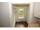 A small walk-in pantry provides extra storage space with natural lighting at 1216 Mountain Ave, Gastonia, NC 28052