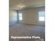 Spacious bedroom with plush carpeting and natural light streaming through large windows at 12184 Muscadine Ct, Midland, NC 28107